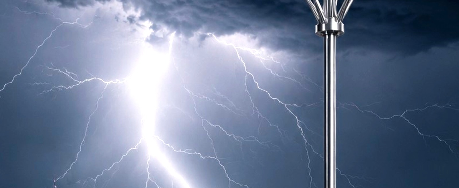 Lightning striking above a commercial structure